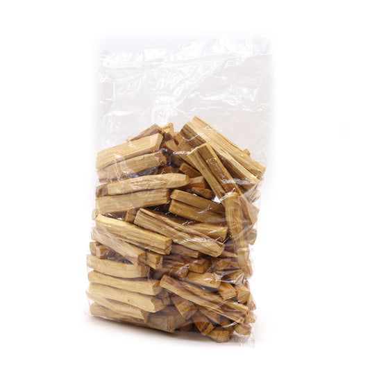 Clear plastic bag filled with wooden sticks palo santo on a white background