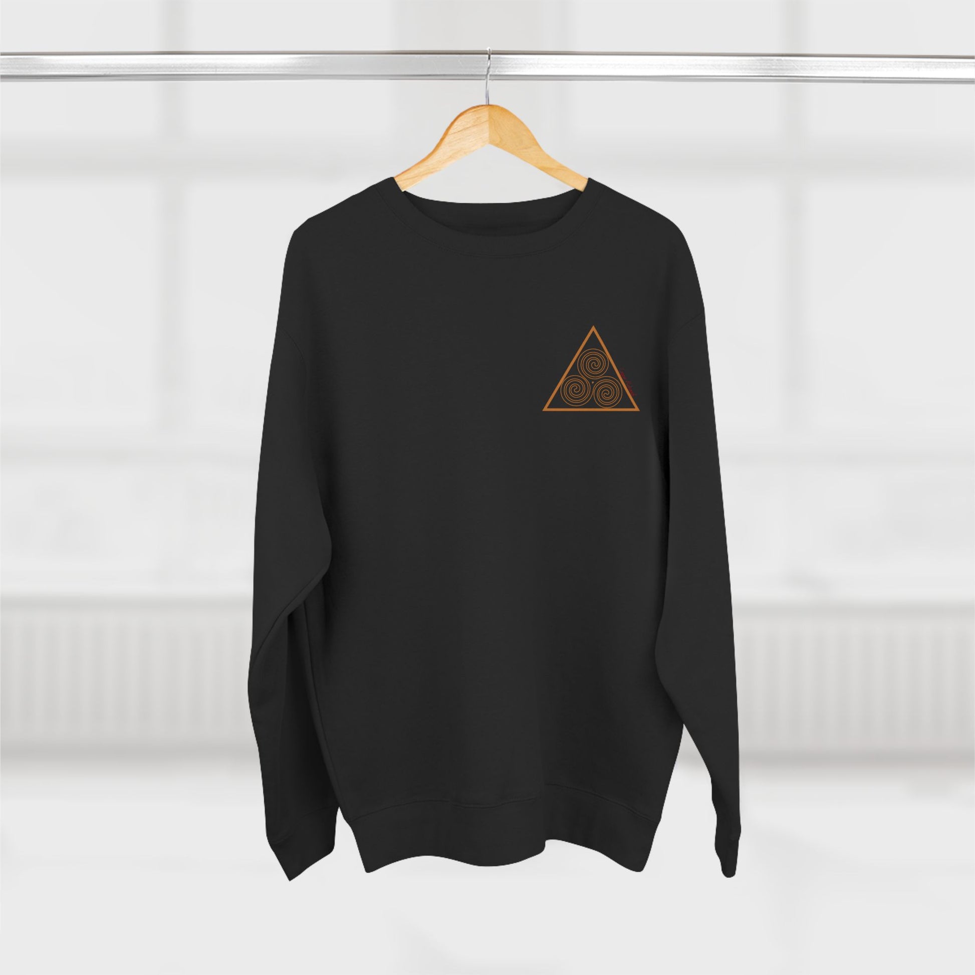 sacred geometry print of a triskelion on a black sweatshirt