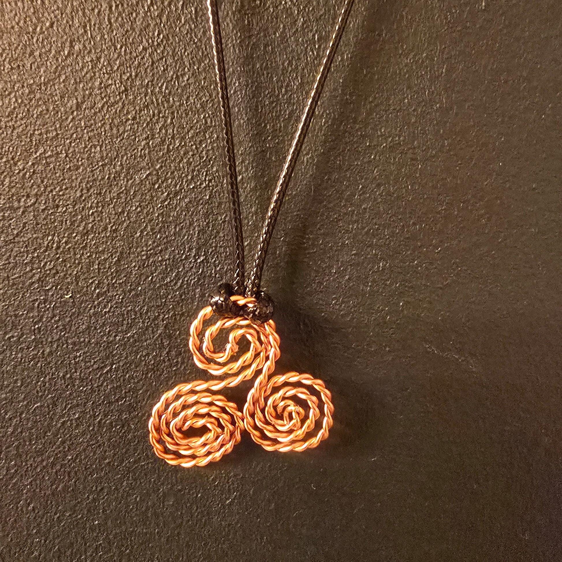 triscelion necklace with black cord